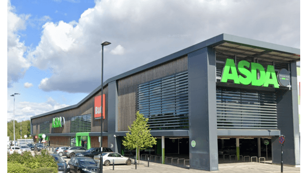 Pay & Display parking area outside an ASDA store in Woodhouse, Yorkshire, with cloudy skies and trees nearby.