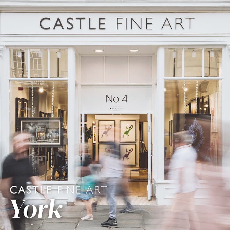 Gallery entrance with large windows displaying framed art, people walking past, and the name "Castle Fine Art" prominently featured.