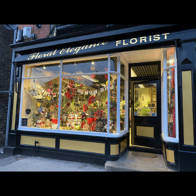 Charming florist shop with vibrant floral displays and decorative signage, showcasing a variety of colorful flowers.