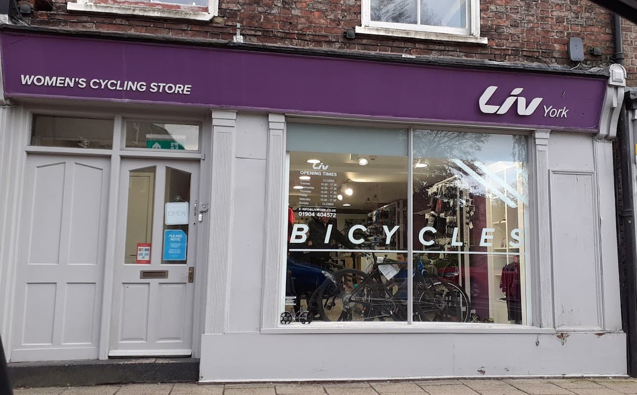 Women's cycling store with large window display featuring bicycles and "Liv York" signage above.