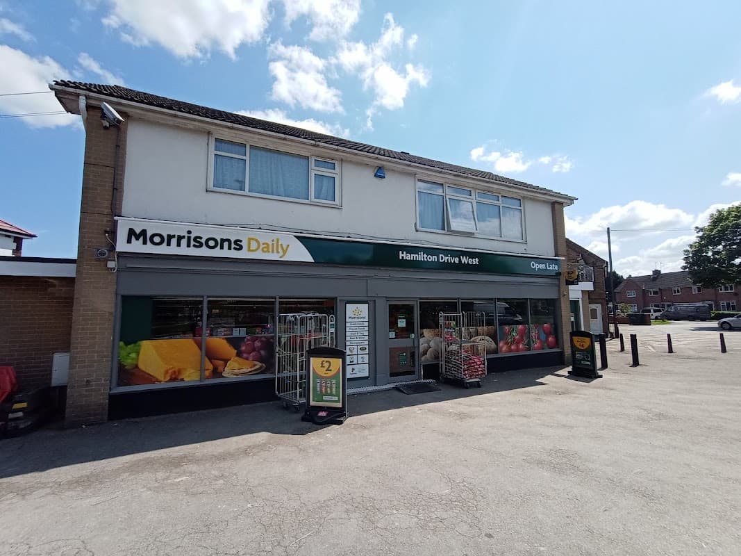 Morrisons Daily storefront with large windows, colorful produce displays, and an "Open Late" sign in York, Yorkshire.