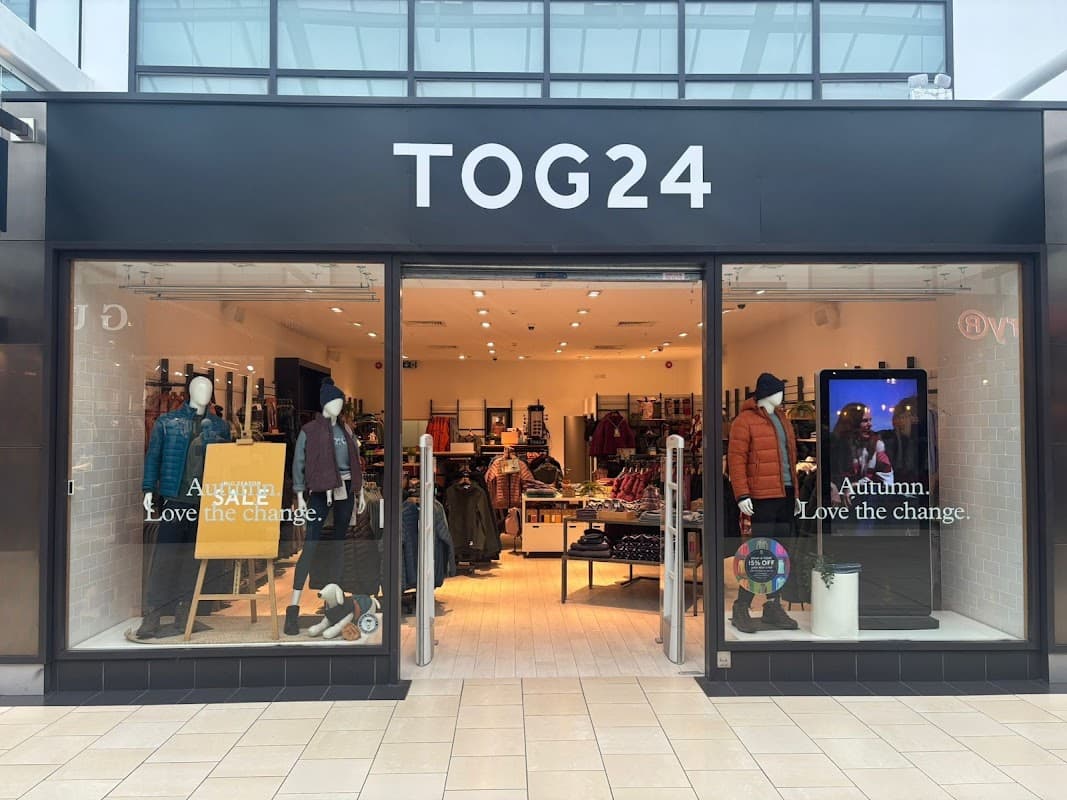 TOG24 store entrance featuring clothing displays, sale sign, and autumn-themed decor in York, Yorkshire.