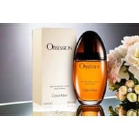 Calvin Klein Obsession Eau de Parfum 100ml, amber liquid in oval bottle with dark cap, next to cream box.