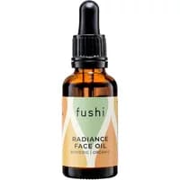 Amber glass bottle of Fushi BioVedic Radiance Face Oil with black dropper and colorful label.