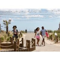 Family Fun "Seashore" puzzle featuring a beach scene with a family walking on a sandy path under string lights.