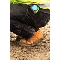 Brown Amblers Safety Fs226 industrial safety boot with reinforced toe, worn by person kneeling on muddy ground.