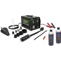 Sealey VS868KIT Leak Detector with black case, various nozzles, hoses, clamps, and two bottles of diagnostic oil.