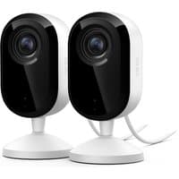 White Arlo Essential 2K indoor security cameras with black lens, mounted on round bases, wired connection.