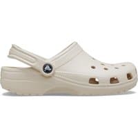 Beige Crocs Classic clog with ventilation holes, adjustable heel strap, and textured sole.
