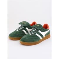 Gola women's evergreen trainers with off-white stripes, gum sole, and orange heel detail.