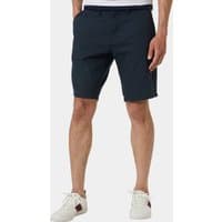 Navy blue men's shorts with side pockets and belt loops, worn by a model with white sneakers.