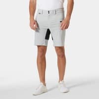 Grey Helly Hansen men's deck shorts with black side pocket, belt loops, and button closure, worn with white sneakers.