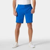 Blue Helly Hansen men's shorts, knee-length, with belt loops and side pockets, worn by model with white sneakers.