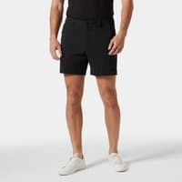 Black Helly Hansen men's shorts, 6-inch length, tailored fit, belt loops, front pockets, worn by model with white shoes.