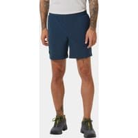 Navy blue Helly Hansen men's shorts, knee-length with elastic waistband, worn by a model with tattoos.