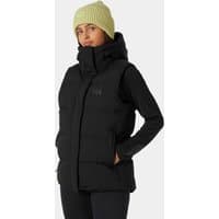 Black Helly Hansen women's puffy vest with high collar and quilted design, worn over a long-sleeve shirt.