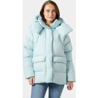 Blue Helly Hansen women's puffer jacket with large hood, quilted design, and front pockets, worn by a model.