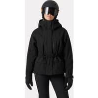 Black Helly Hansen women's ski jacket with hood, front zipper, and adjustable waist, worn by a model with helmet and gloves.