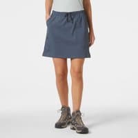 Blue Helly Hansen hiking skort, XS, with drawstring waist and side pockets, worn by a model with hiking boots.