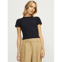 Black Jjxx Gigi Baby Tee, short sleeves, fitted style, crew neck, worn by model with beige pants.