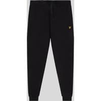 Jet black skinny fit cotton joggers with elastic waistband, drawstring, and yellow logo on left thigh.