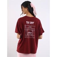 Zinfandel short-sleeve top with "The Spot" graphic on back, worn by model with long hair and pink bow.