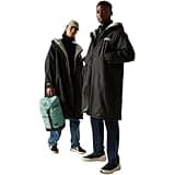 Regatta waterproof robe, black with borg lining and hood, worn by two models, ideal for outdoor water activities.