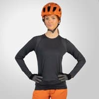 Matt grey long-sleeve women's jersey by Endura, worn with orange helmet and shorts, featuring a sleek, fitted design.