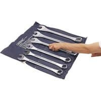 Draper 6 piece long combination spanner set, 33-50mm, silver wrenches on a blue fabric holder, hand reaching for one.