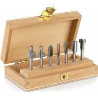 Dremel 7 Piece Router Bit Set in a wooden box with brass latch, featuring various metal bits for detailed woodworking.
