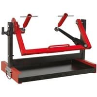 Red and black Sealey motorcycle engine stand for single/twin cylinders with adjustable arms and sturdy base.