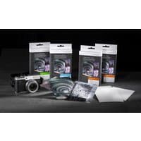 Hahnemühle White Pearl photo paper packs with camera, showing glossy sheets and spiral design packaging.