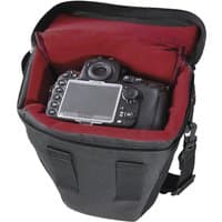 Black Hama Valletta Compact case with red interior, holding a DSLR camera, featuring a shoulder strap and secure closure.