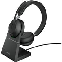 Black Jabra Evolve2 65 USB-C stereo headset on charging stand with cushioned ear cups and adjustable headband.