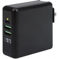 Black Manhattan 4-in-1 travel charger with USB-C, 2 USB-A ports, wireless pad, and interchangeable plugs.