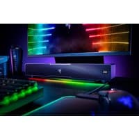 Black Razer Leviathan V2 soundbar with RGB lighting, sleek design, and Razer logo on front, under a monitor.