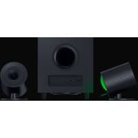 Black Razer Nommo V2 speakers with cylindrical design, green lighting, and central subwoofer with control panel.