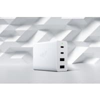 White Razer mobile device charger with three USB ports and embossed logo on a geometric patterned background.