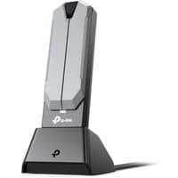 Black and gray TP-Link BE6500 WLAN adapter with vertical stand and LED indicator.
