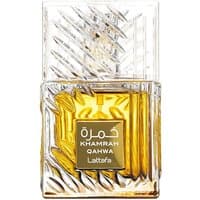 Transparent glass bottle with textured design, gold label reading "Khamrah Qahwa," containing amber liquid, by Lattafa.
