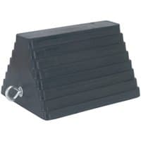 Black Sealey rubber wheel chock with a textured surface, triangular shape, and metal ring on the side.