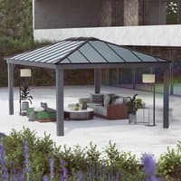 Grey Palram Canopia gazebo with slanted roof, metal frame, and spacious interior over patio furniture.
