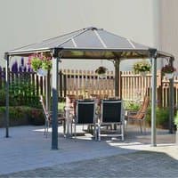 Hexagon grey garden gazebo with metal frame and clear roof panels, surrounded by patio chairs and hanging plants.