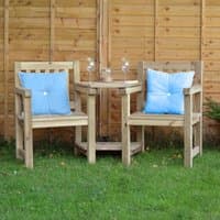 Wooden garden love seat with two chairs, blue cushions, and a round table, set on grass in front of a wooden fence.