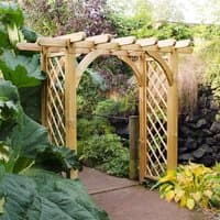 Wooden garden pergola arch with lattice sides and curved top, surrounded by lush greenery.