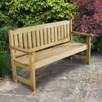 Wooden garden bench with slatted backrest and seat, natural finish, set on a stone patio with greenery in the background.