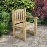 Wooden garden chair with slatted back and seat, natural finish, sturdy armrests, set on a stone patio with greenery.