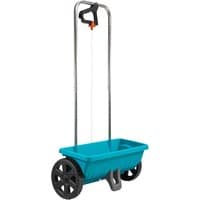 Blue Gardena spreader with large black wheels, tall metal handle, and orange trigger for grass and salt distribution.