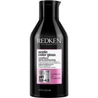 Redken Acidic Color Gloss Conditioner 500ml in a black bottle with a pink label and white text detailing pH level.