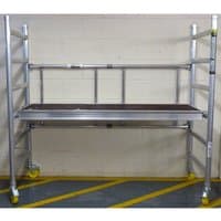 Aluminum Werner Mini-Max work tower with yellow wheels, adjustable platform, and safety rails.